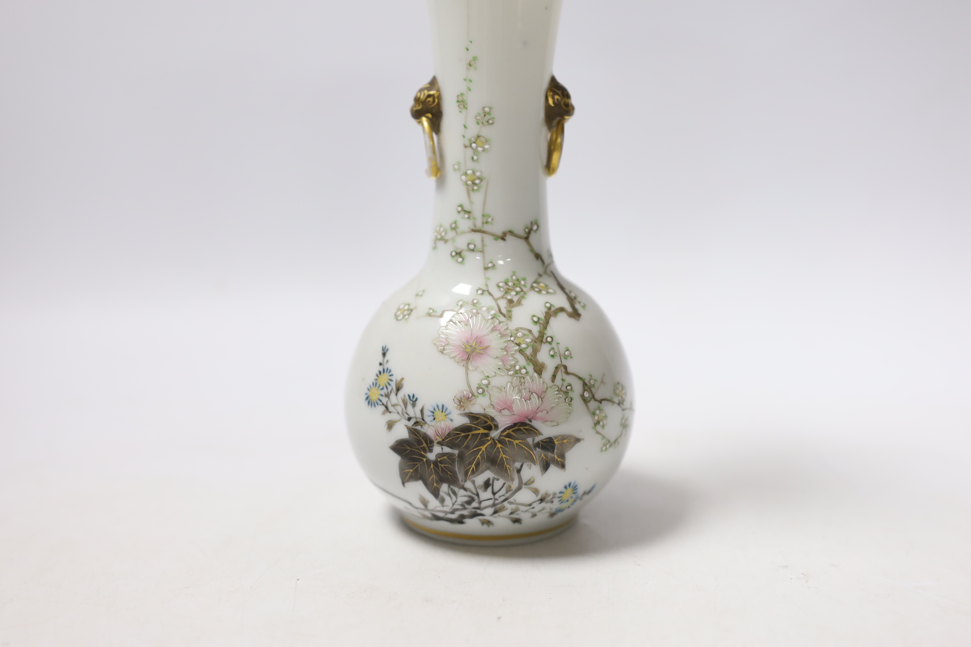 A Japanese bottle vase with lion mask and ring handles, together with a hardstone disc